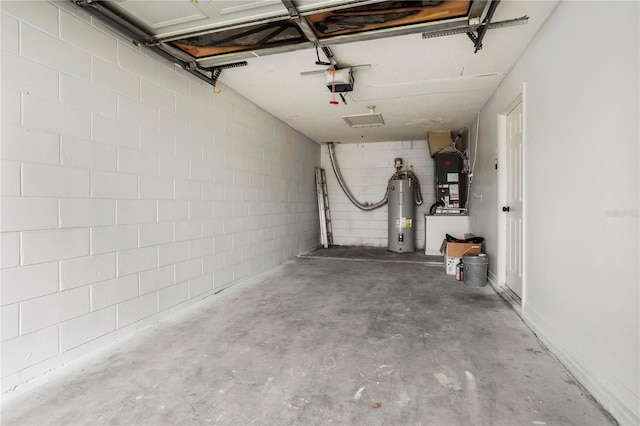 garage featuring a garage door opener, electric water heater, and heating unit