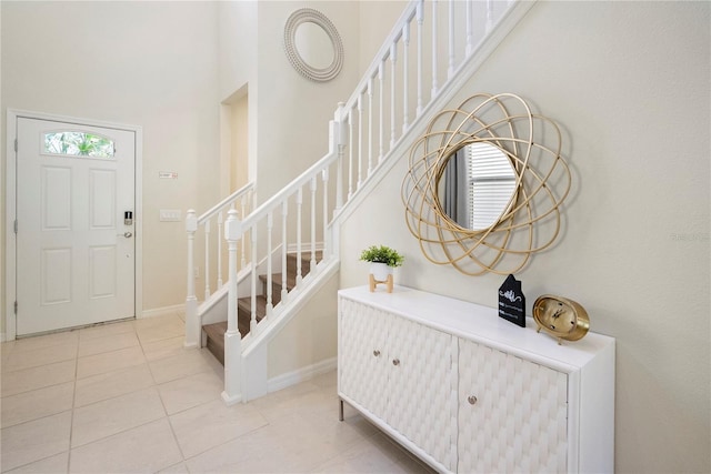 foyer featuring a high ceiling and light tile patterned flooring