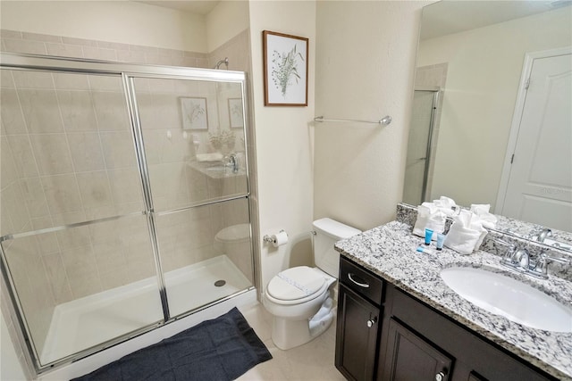 8896 Bengal Ct, Kissimmee, FL 34747 - bathroom featuring vanity, toilet, and a shower with door