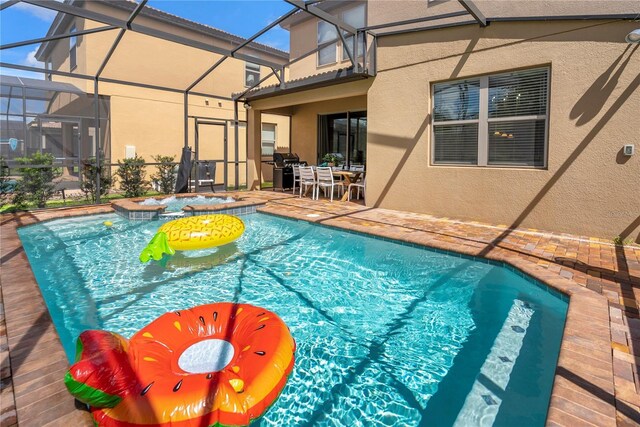 8896 Bengal Ct, Kissimmee, FL 34747 - view of swimming pool with an in ground hot tub, a patio, and glass enclosure