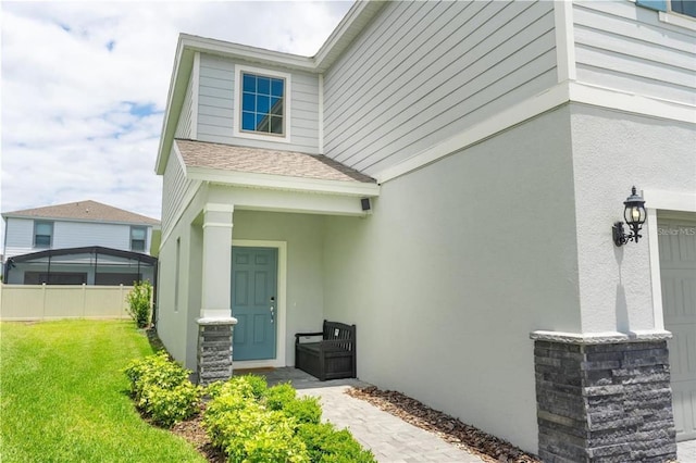 view of exterior entry featuring a yard