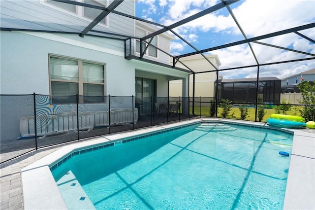 view of pool with glass enclosure