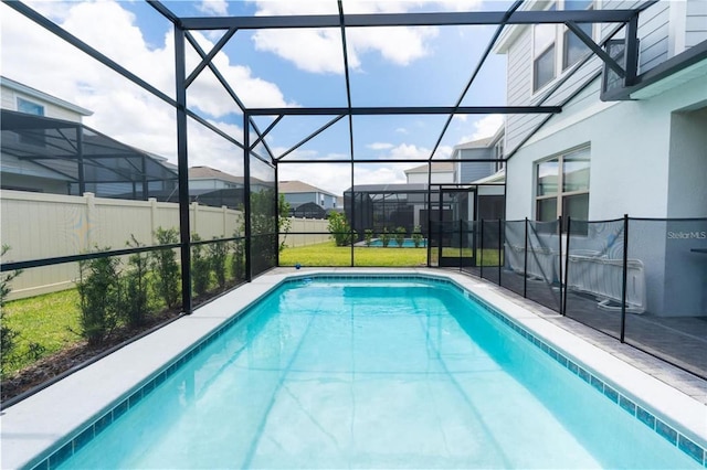 view of swimming pool featuring a lanai