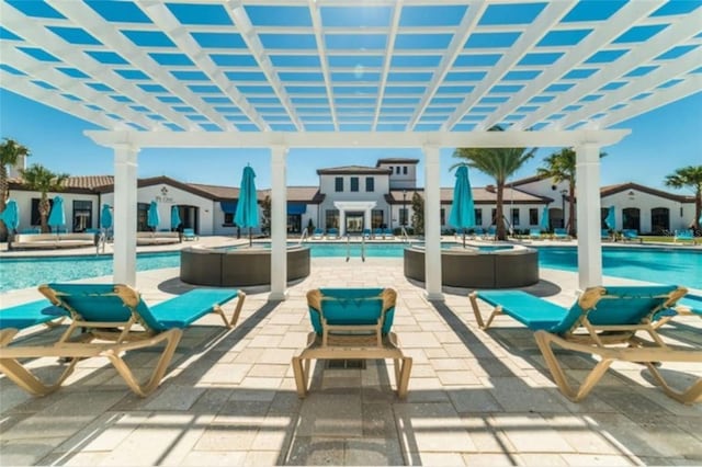 view of patio with a community pool and a pergola