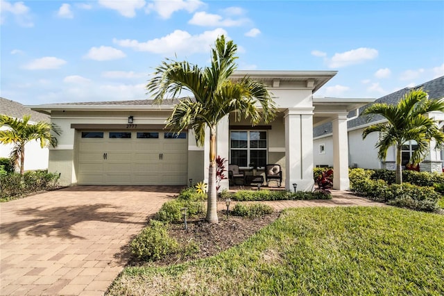 view of front of house with a garage and a front lawn