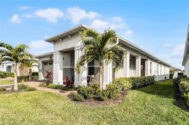 view of front of home with a garage and a front lawn