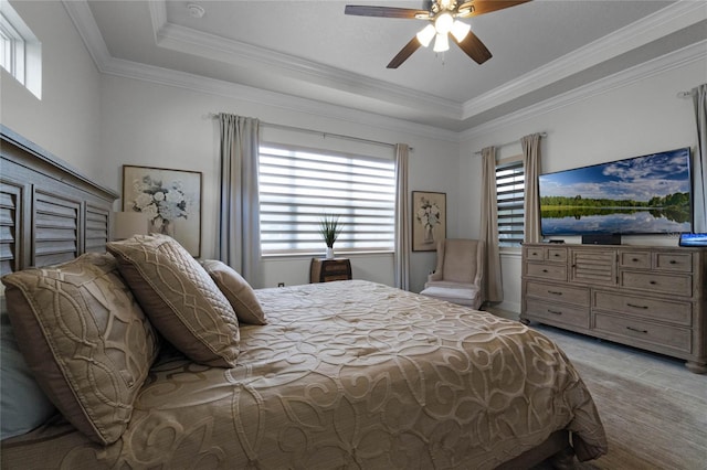 bedroom with ornamental molding, a raised ceiling, and ceiling fan