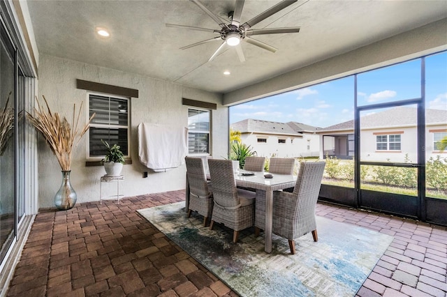 sunroom / solarium with ceiling fan and a healthy amount of sunlight