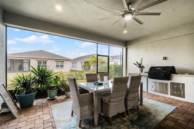 sunroom / solarium featuring ceiling fan