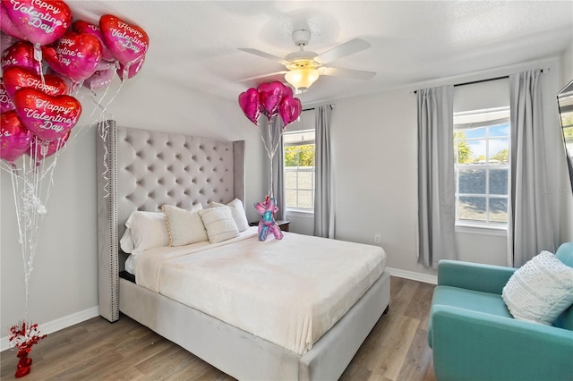 bedroom featuring hardwood / wood-style floors and ceiling fan