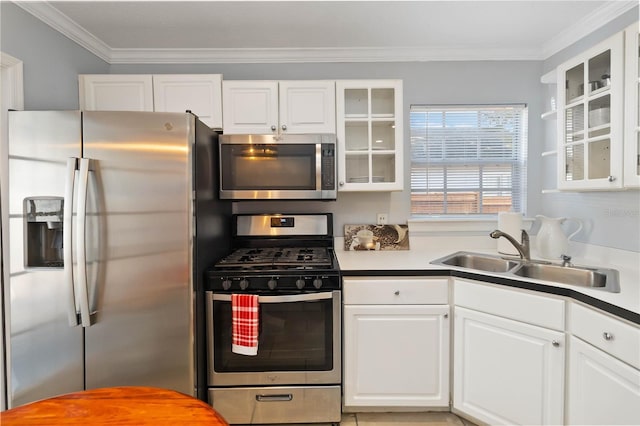 kitchen with stainless steel appliances, white cabinetry, sink, and ornamental molding