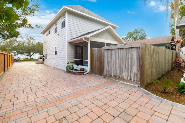 rear view of property featuring a patio area