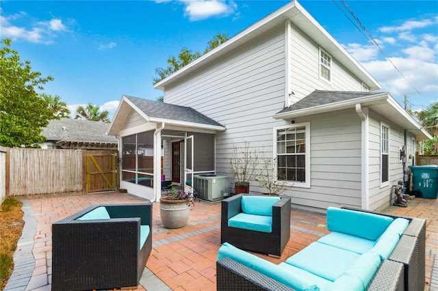 rear view of property featuring an outdoor living space, central AC, a sunroom, and a patio area