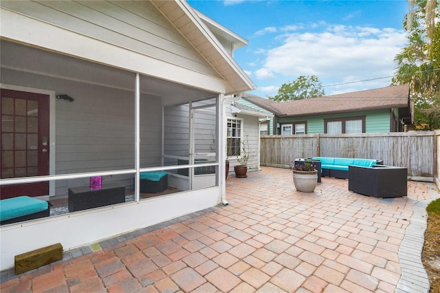 view of patio with an outdoor living space and a sunroom