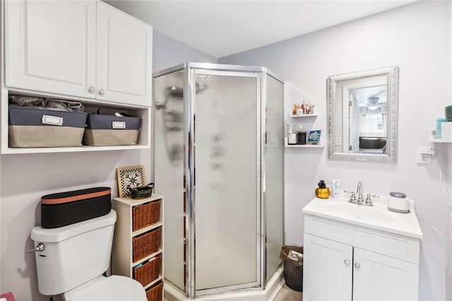 bathroom featuring vanity, toilet, and walk in shower