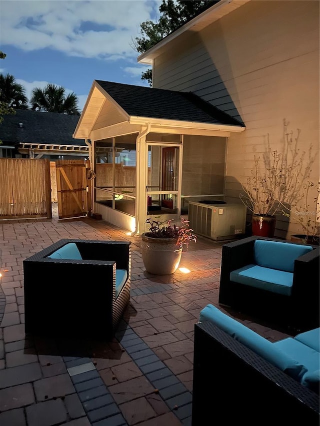 patio terrace at dusk featuring an outdoor living space