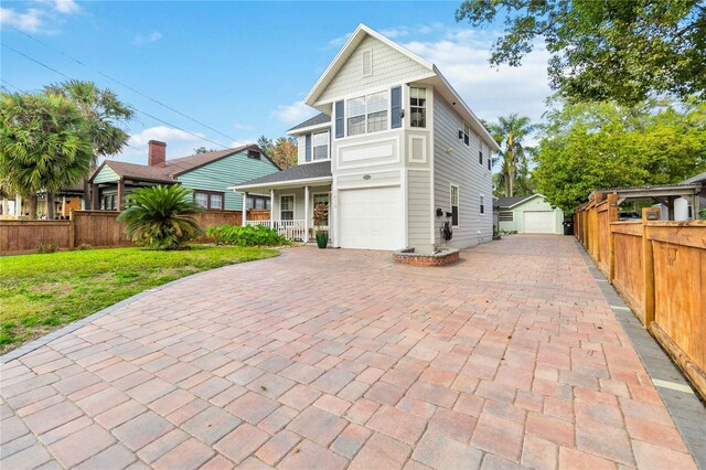 view of front facade with a porch, a garage, and a front lawn