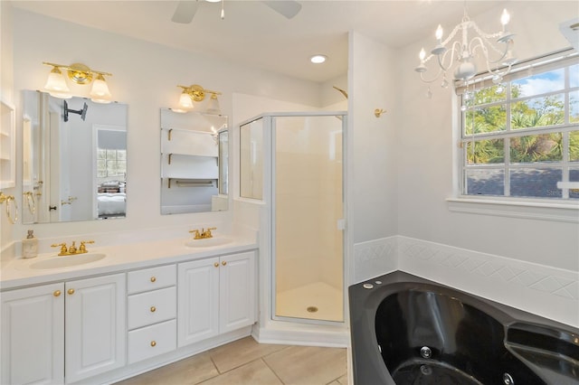 bathroom with a healthy amount of sunlight, vanity, tile patterned floors, and separate shower and tub