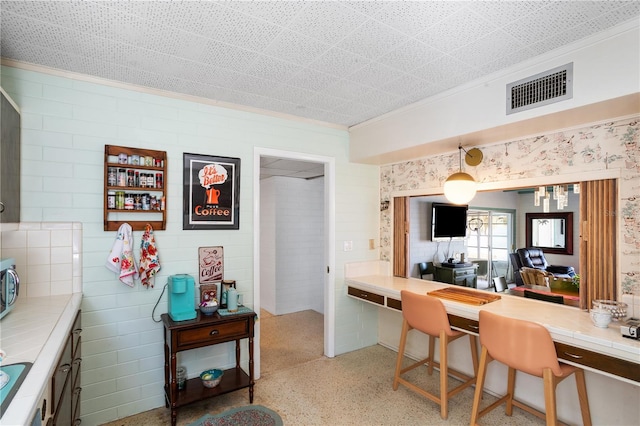 814 S Lakeshore Blvd, Lake Wales, FL 33853 - kitchen featuring ornamental molding and tile counters