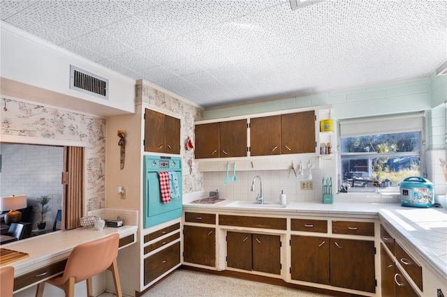 814 S Lakeshore Blvd, Lake Wales, FL 33853 - kitchen featuring sink, tasteful backsplash, dark brown cabinetry, ornamental molding, and oven