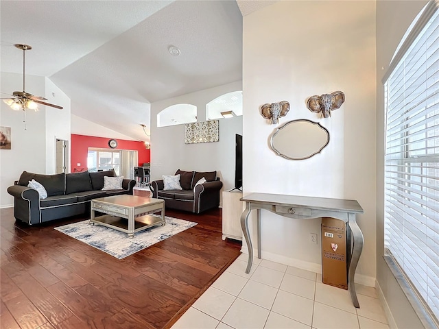 living room with light hardwood / wood-style flooring, high vaulted ceiling, and ceiling fan