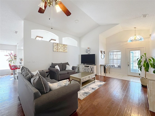 living room featuring ceiling fan, wood-type flooring, high vaulted ceiling, and a textured ceiling