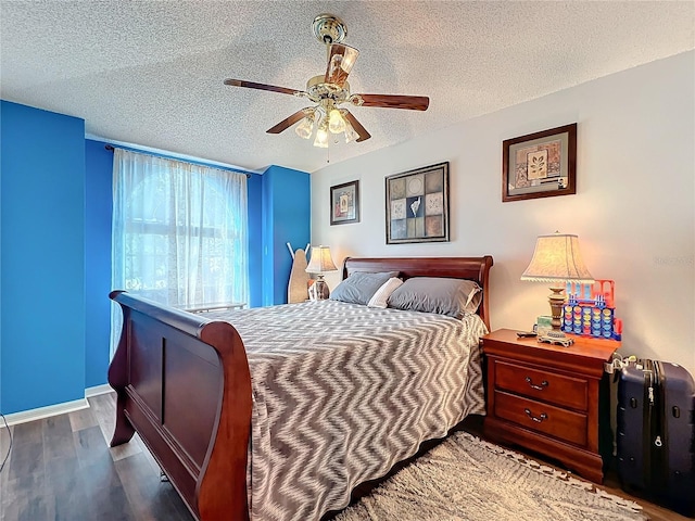 bedroom with hardwood / wood-style floors, a textured ceiling, and ceiling fan