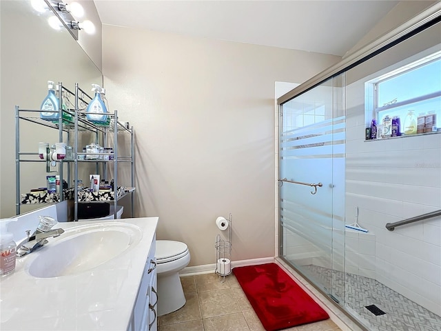 bathroom featuring vanity, tile patterned floors, toilet, and walk in shower