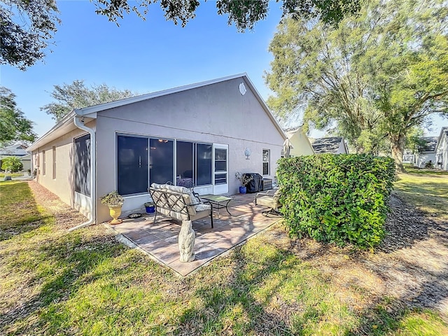 back of house featuring a yard and a patio area