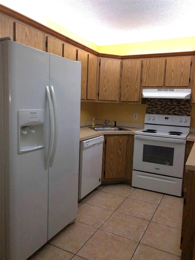 kitchen featuring sink, white appliances, tasteful backsplash, a textured ceiling, and light tile patterned flooring