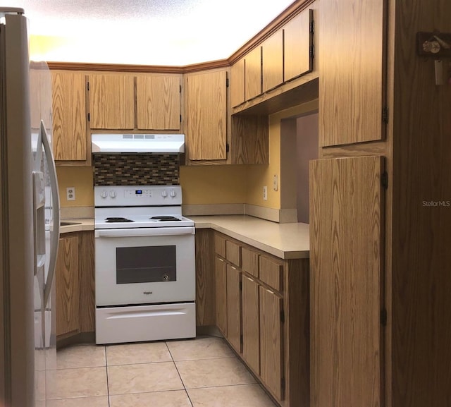 kitchen featuring light tile patterned floors and white appliances