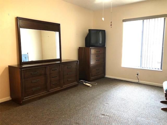 unfurnished bedroom featuring dark carpet