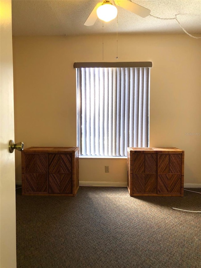 spare room with ceiling fan, carpet floors, and a textured ceiling