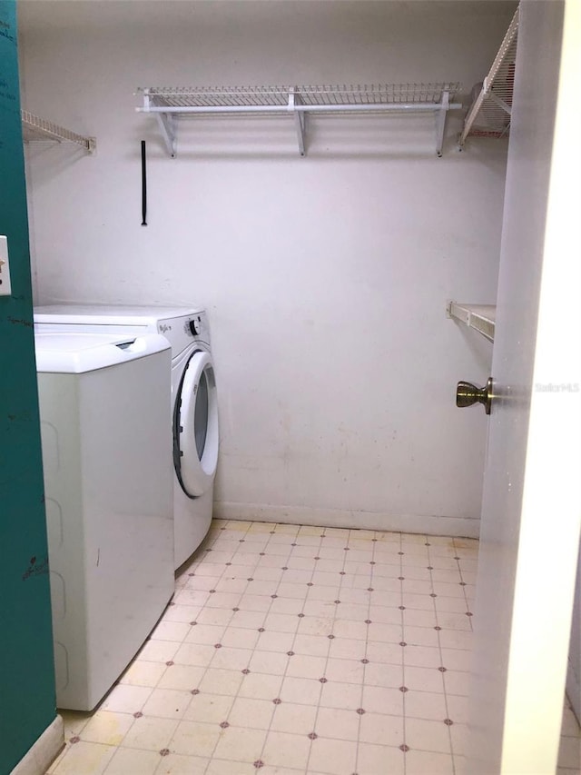 clothes washing area with washer and clothes dryer