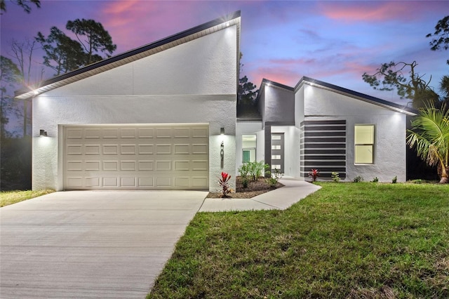 contemporary house with a garage and a lawn