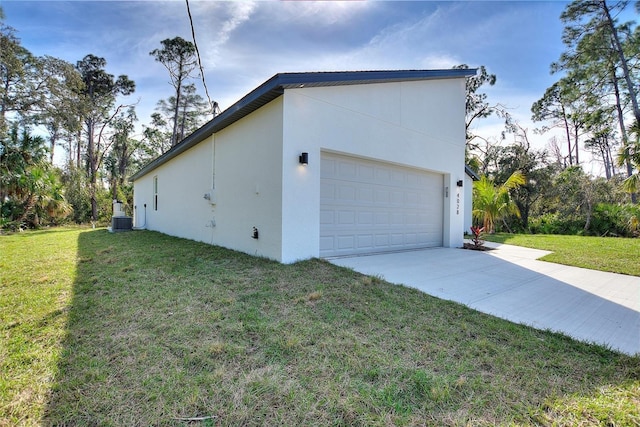 view of home's exterior with cooling unit, a yard, and a garage