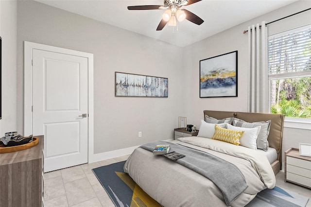 tiled bedroom featuring ceiling fan