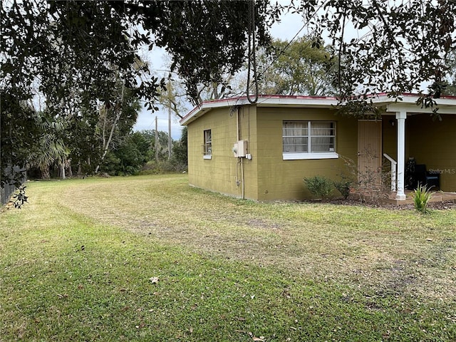 view of property exterior with a yard