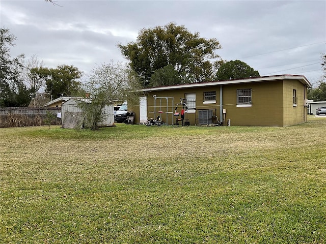 rear view of property with a yard