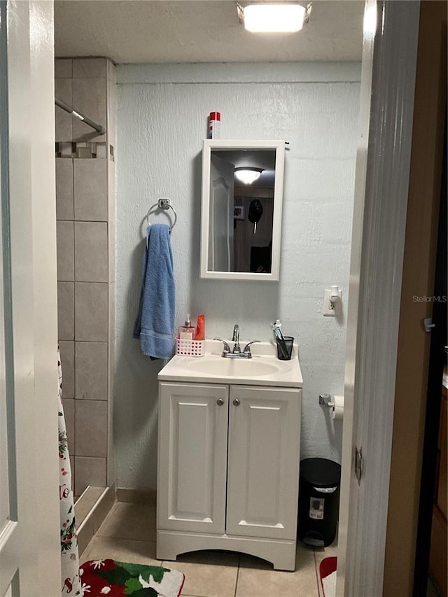 bathroom featuring vanity, curtained shower, and tile patterned floors