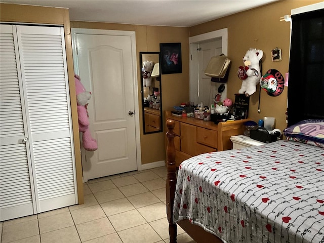 tiled bedroom featuring a closet