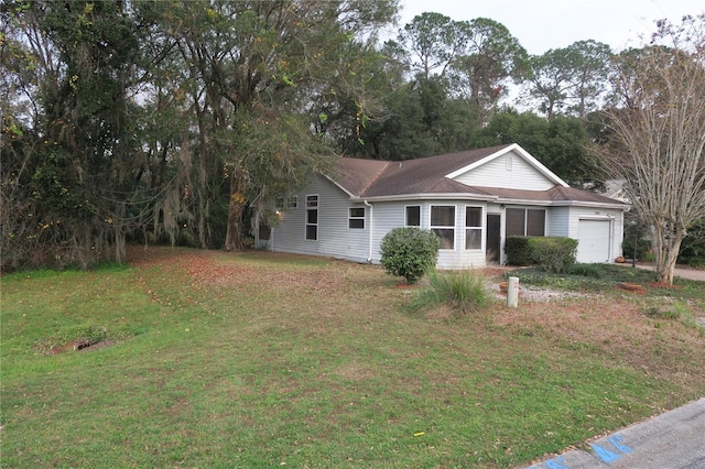 ranch-style home with a garage and a front yard