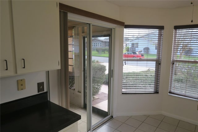 doorway with light tile patterned flooring