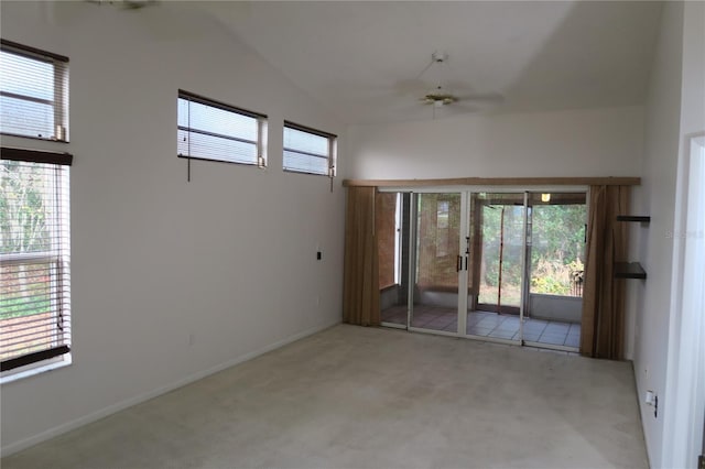 carpeted empty room featuring lofted ceiling and ceiling fan