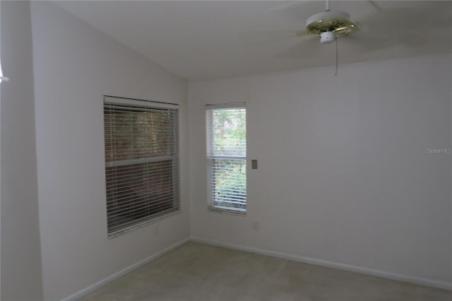 carpeted empty room with vaulted ceiling