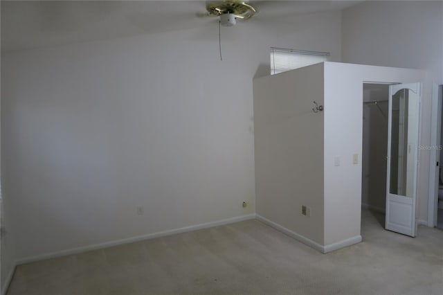 carpeted empty room featuring a towering ceiling