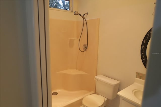 bathroom featuring vanity, toilet, and walk in shower