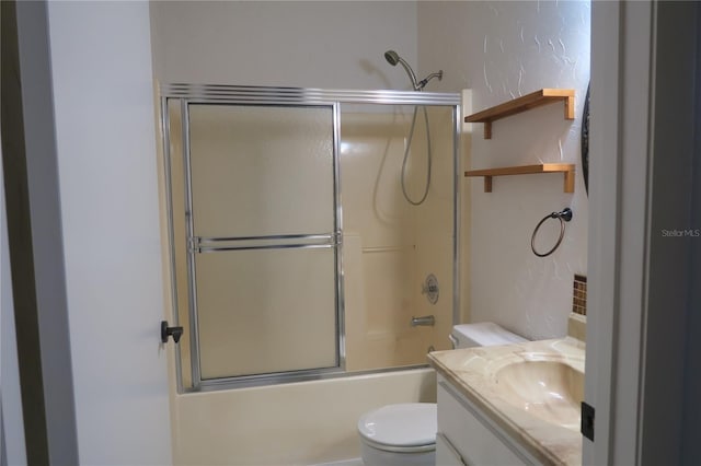 full bathroom featuring vanity, toilet, and combined bath / shower with glass door