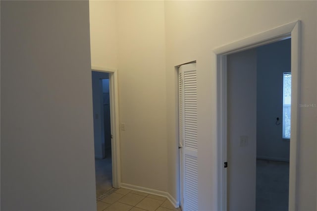 hall with light tile patterned floors