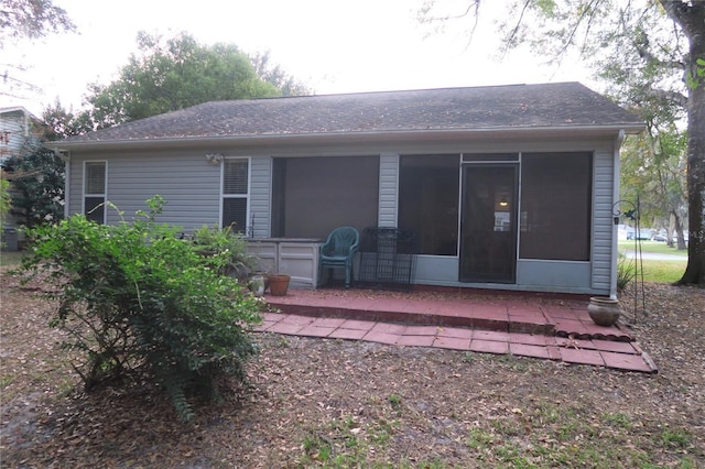 back of property with a patio